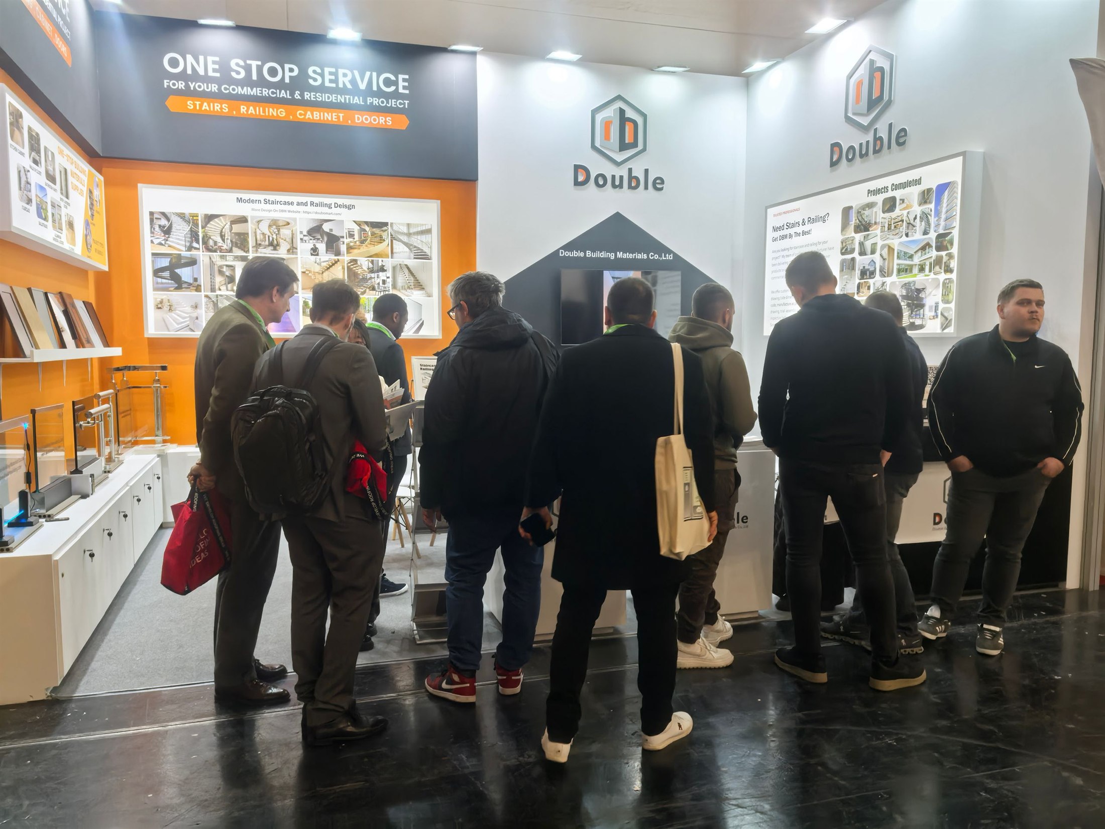 A group of European trade visitors standing at the Double Building Materials stand during BAU 2025 in Munich
