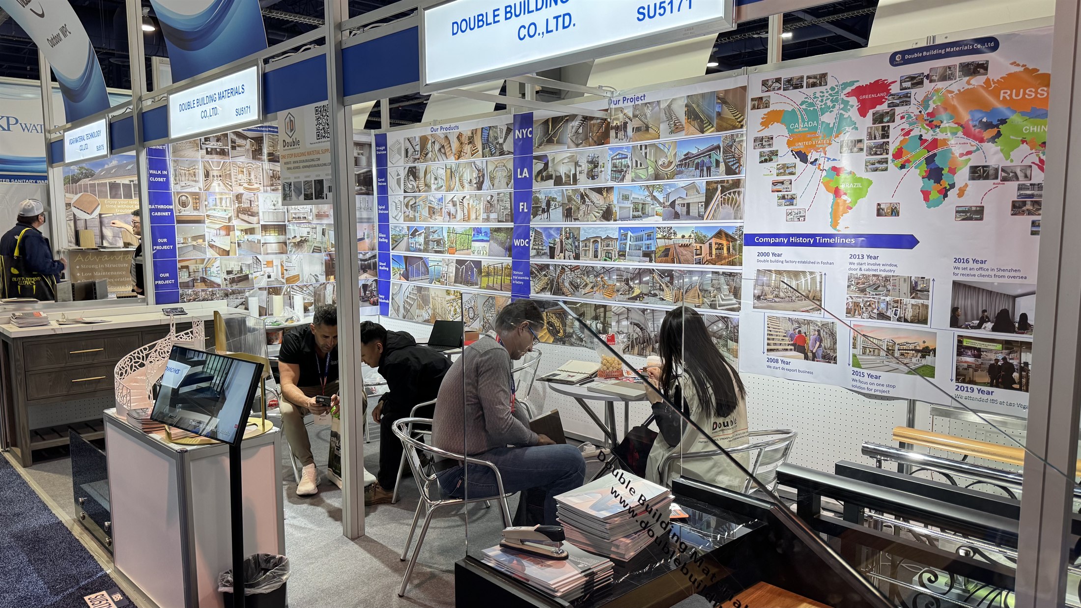 Visitors seated at the consultation table reading catalogues at the Double Building Materials IBS 2025 booth in Las Vegas