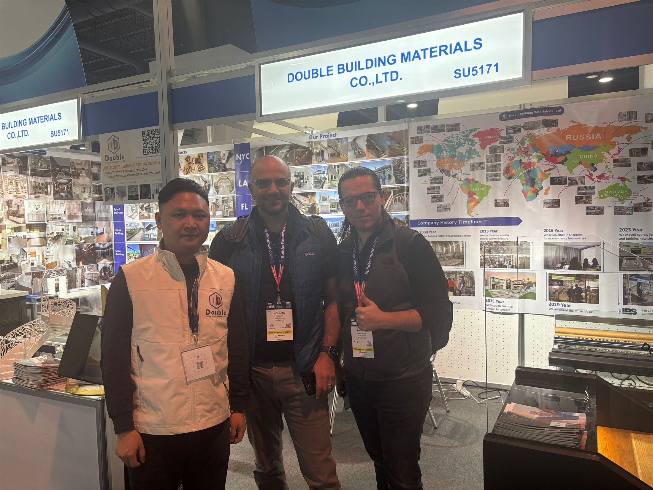 Team members and visitors in front of the world-project map wall at the Double Building Materials booth during IBS 2025 in Las Vegas